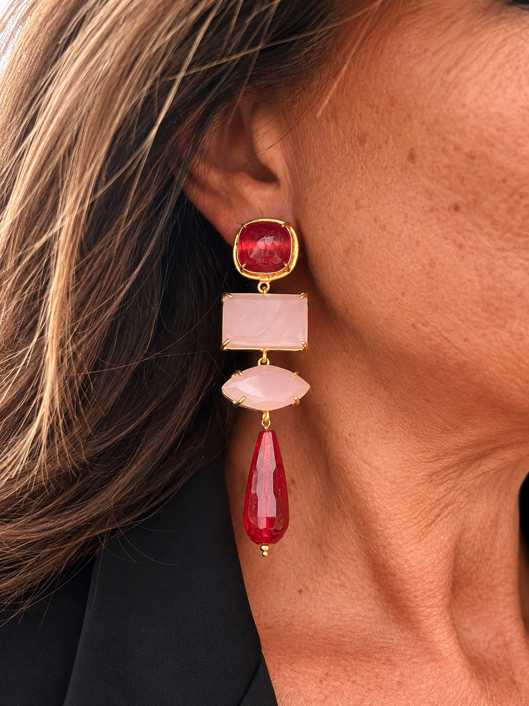 Orecchino lungo rosa e rosso con dettagli color oro e goccia rossa indossato
